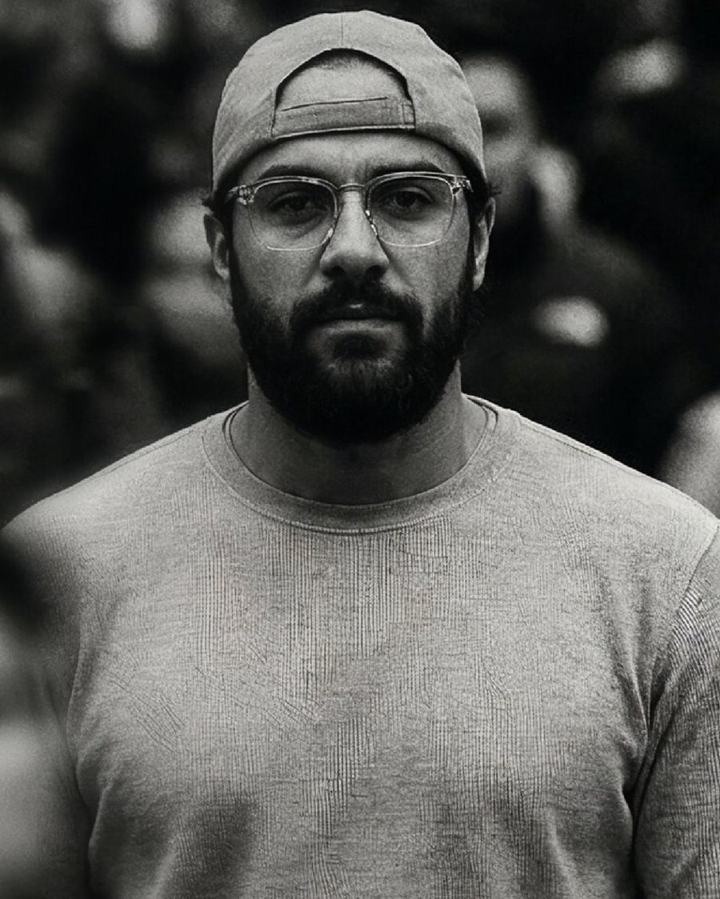 Portrait of Assem Salah amid a city crowd